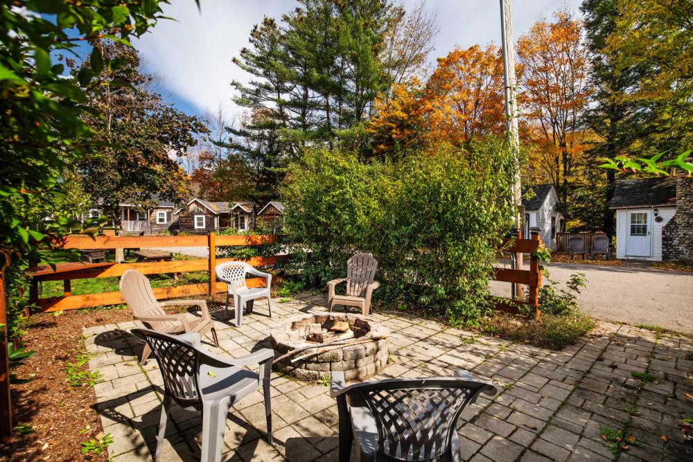 Communal fire pit and little cabins at Pemi Cabins