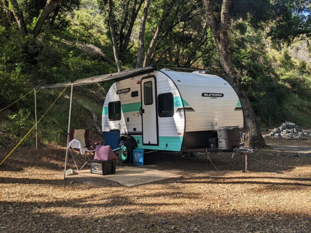 Trailer in a dirt site at Blue Lakes Village RV Park