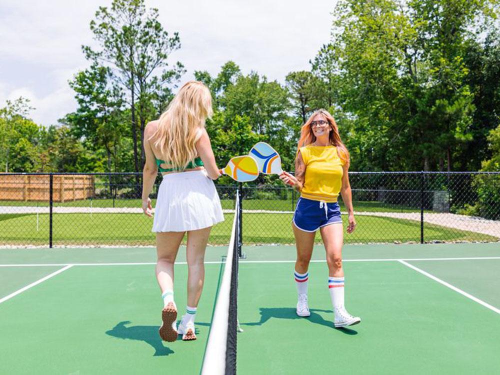 Two women playing pickle ball at OCEANS RV RESORT