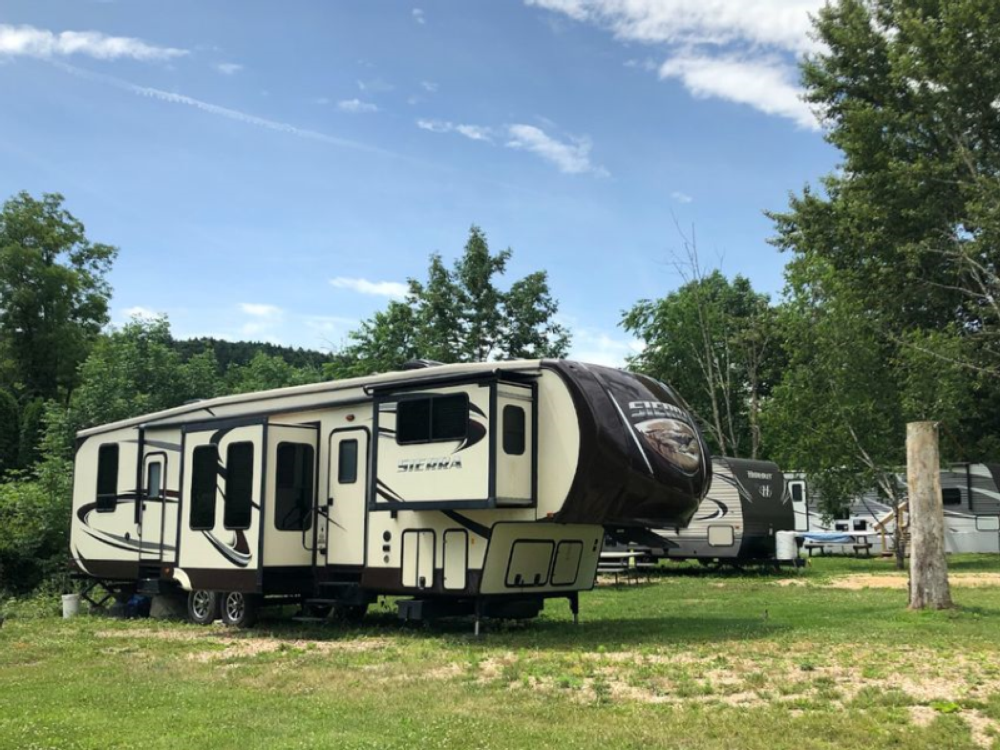 5th wheel in the grass at Pocono Point RV & Campground