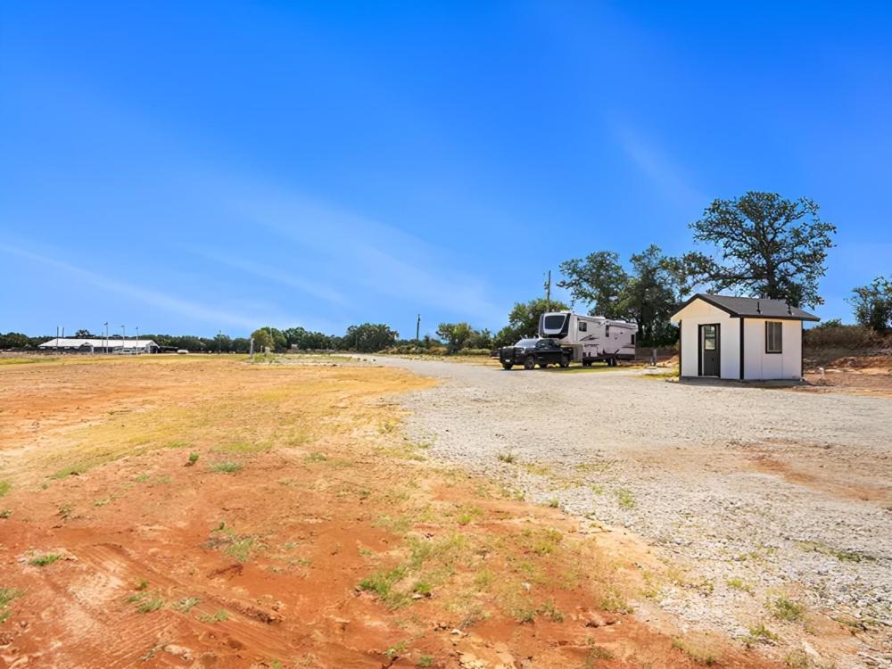 Parked trailer next to outhouse at site Hill City Horse Stop
