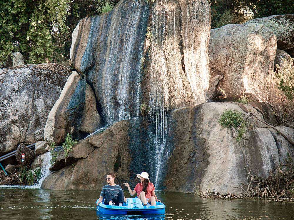 People on a boat near the waterfall