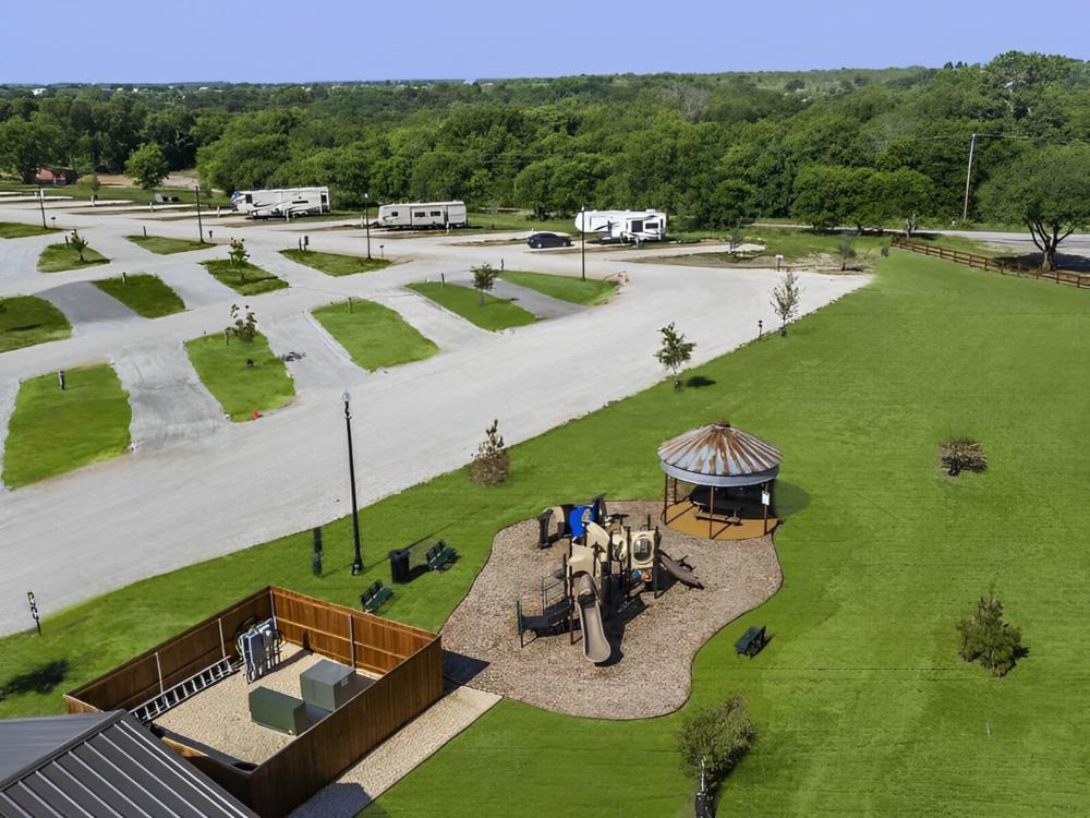 Open RV spaces with parked trailers in the back at LakePoint RV Resort