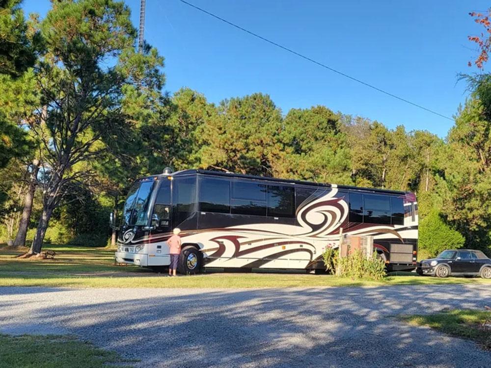 Side view of RV parked in camp site at HITCHINPOST RV PARK AND CAMPGROUND