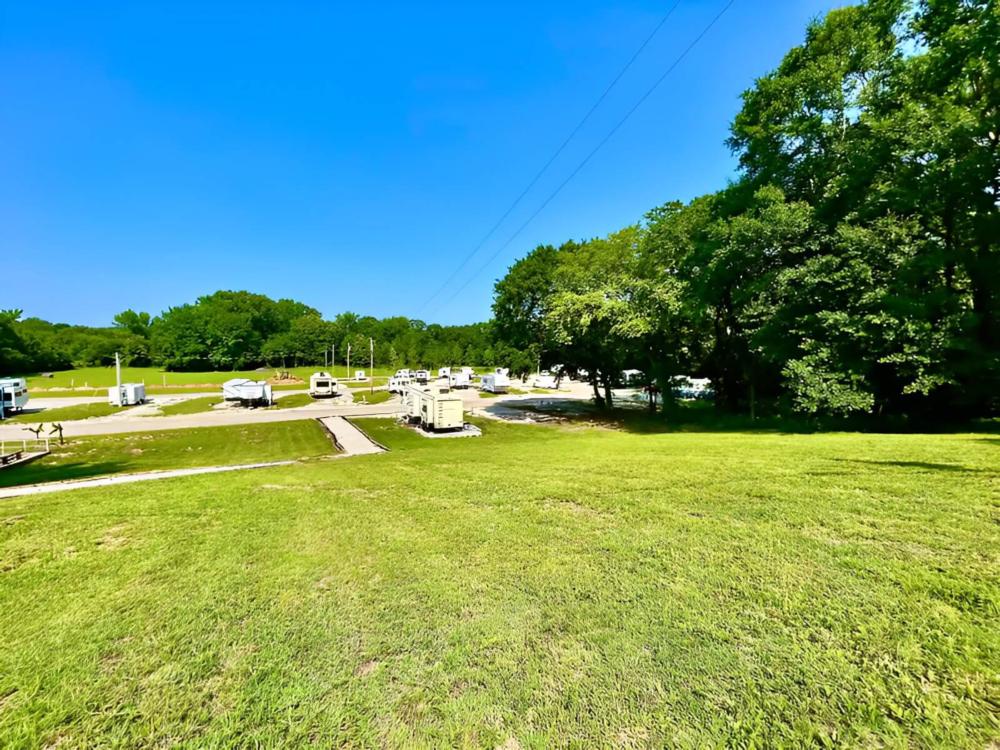 Parked RV's at site The Shoals Cottages & RV Park