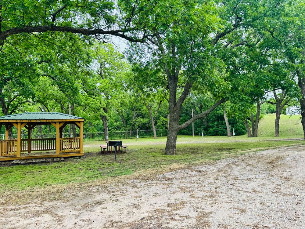 Gazebo, picnic table and grill at RIVERSHIRE RV RESORT & CAMPING