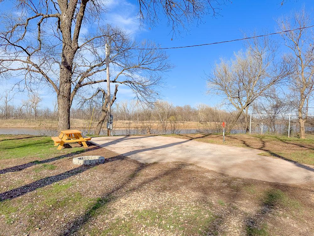 Paved sites with a picnic table and fire pit at RIVERSHIRE RV RESORT & CAMPING