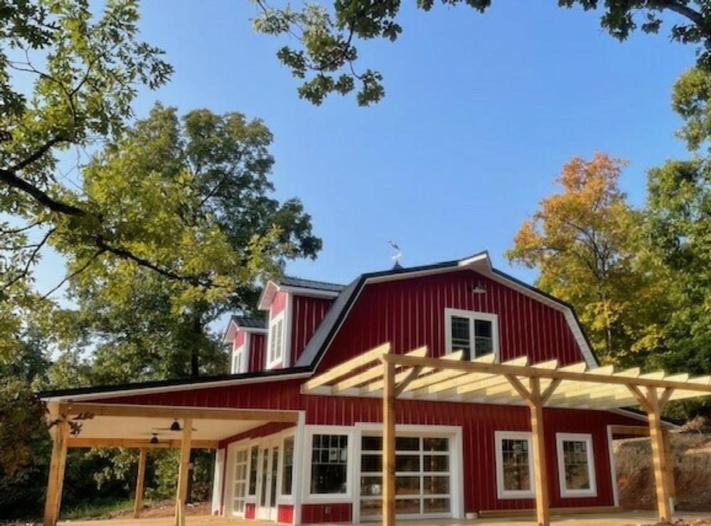 Barn surrounded by trees at Ozark Adventures RV Campgrounds