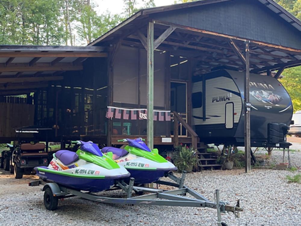 Covered RV port and jet skis at Barefoot Landing Camping Resort