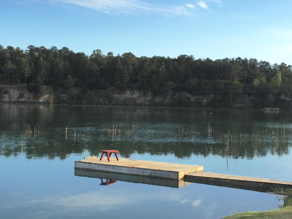 Red bench on a dock on the lake at St Stephens Historical Park