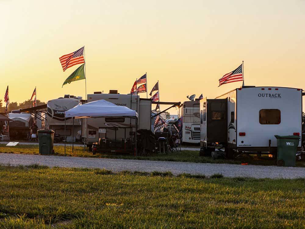 Parked RVs with flags flying high at WORLD WIDE TECHNOLOGY RECEWAY CAMPGROUND