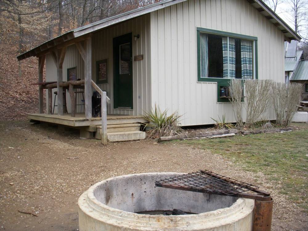 A rental cabin with a porch and fire pit