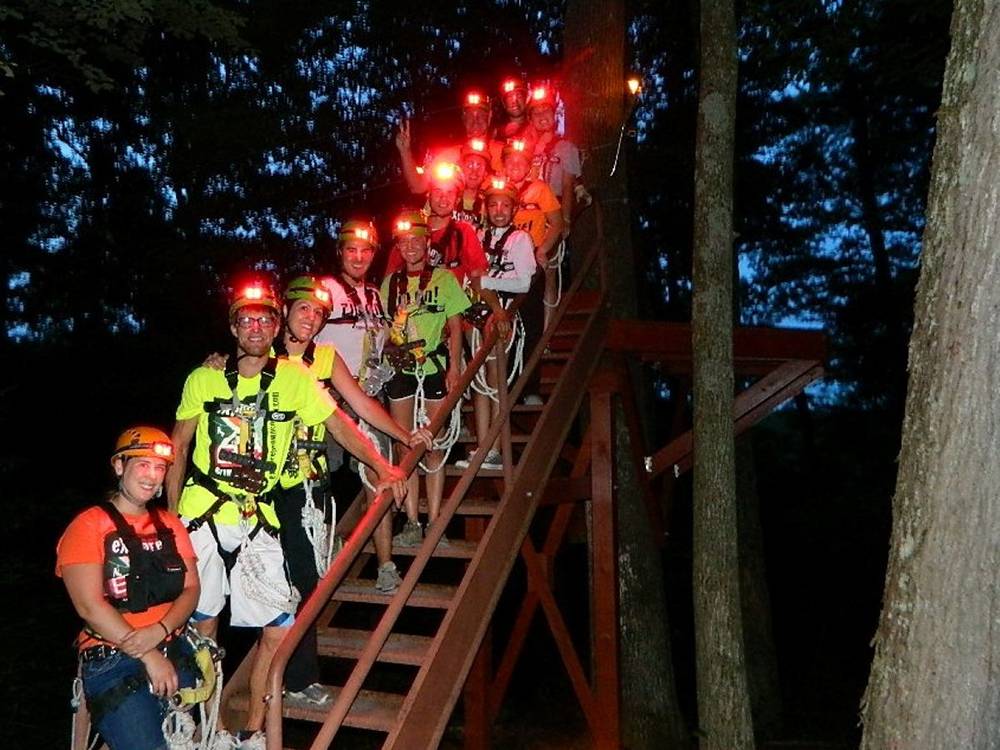 A group of people with lighted hardhats