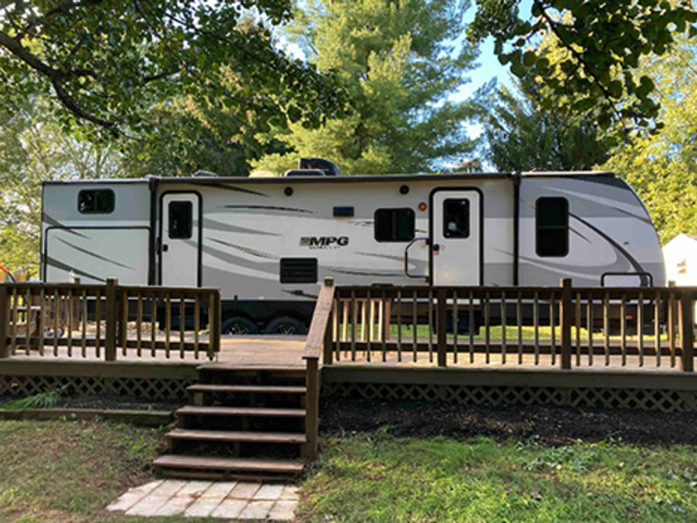 Trailer with wood deck at Cedar Lake Family Campground