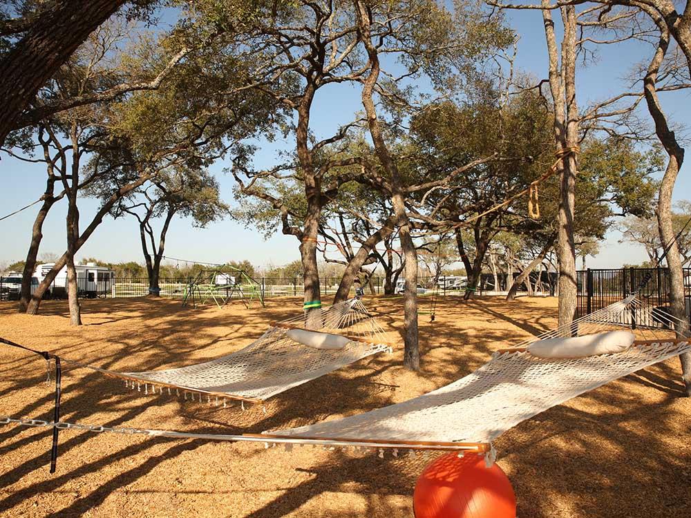 Two hammocks hanging in the playground area at GATHER CAMPGROUND BELL COUNTY