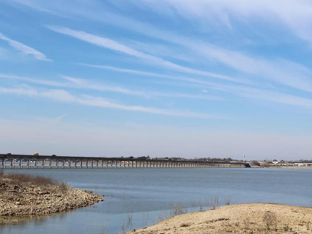 Lake with bridge in background at BRIDGEVIEW RV PARK