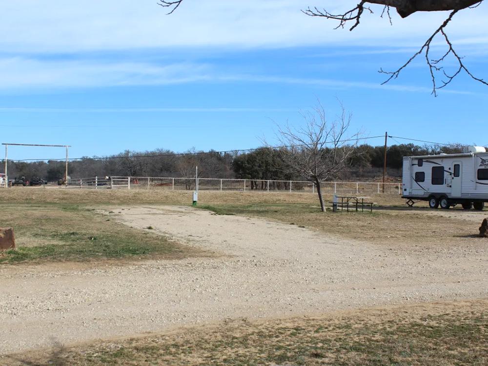 A view of an empty gravel site at BRIDGEVIEW RV PARK