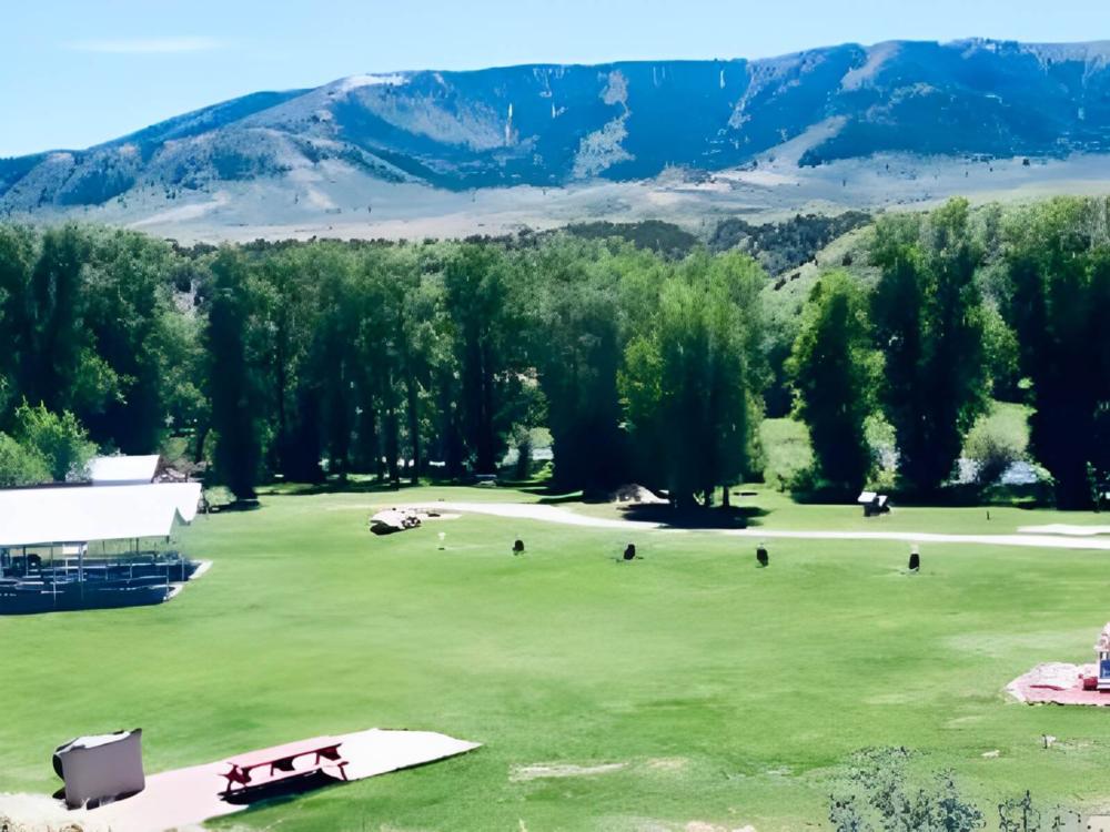 Open grass area at site Over the Hill RV Park