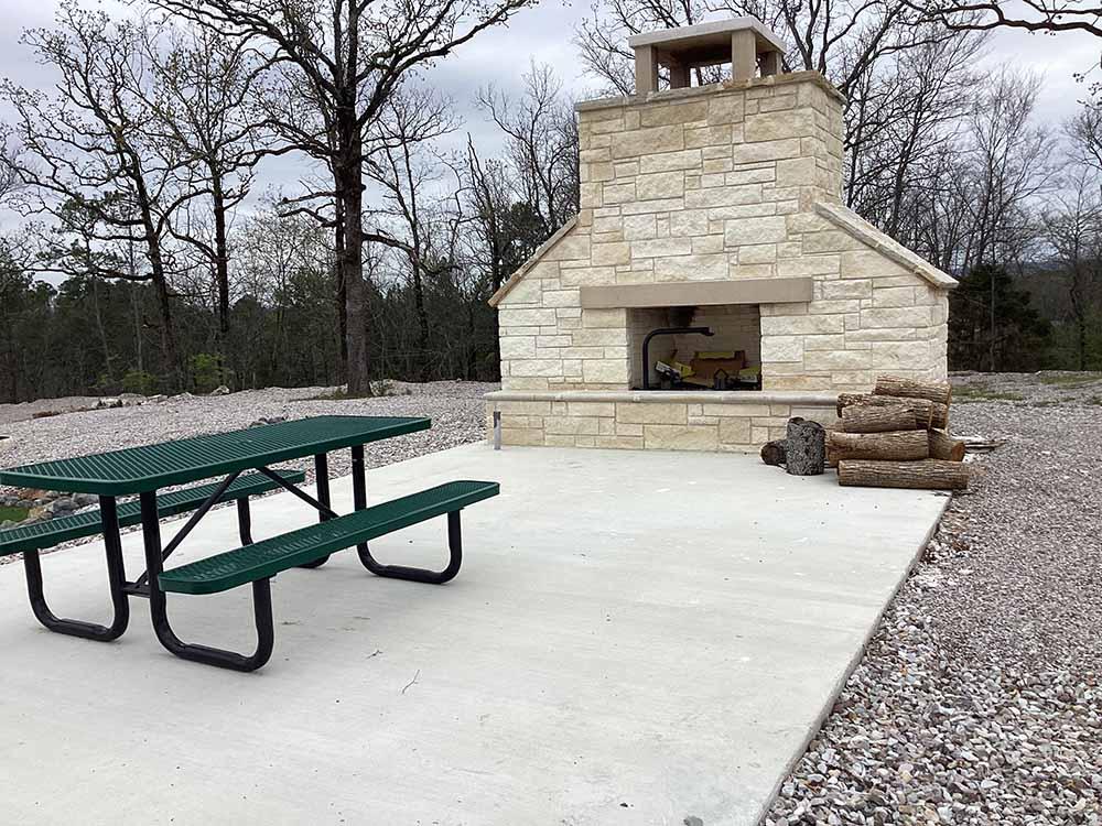 A large fireplace and picnic table at HOT ROD HILL RV PARK