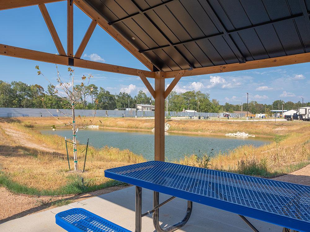 A shaded picnic bench at NEW CANEY RV PARK