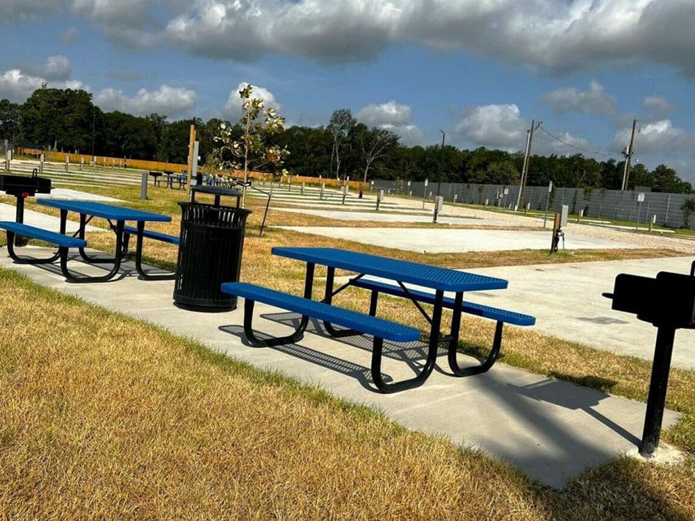 A view of the paved sites and picnic benches at NEW CANEY RV PARK