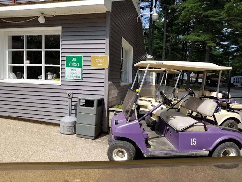 Golf carts parked next to the office building at PEACEFUL PINES FAMILY CAMPGROUND