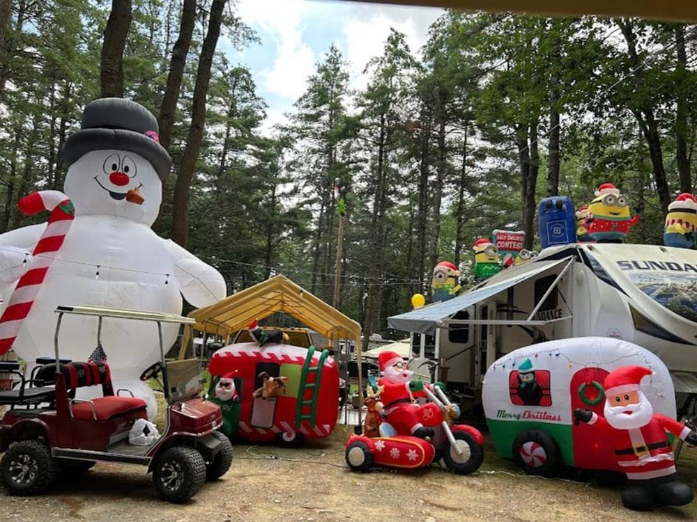 A RV site decorated with Christmas inflatables at PEACEFUL PINES FAMILY CAMPGROUND
