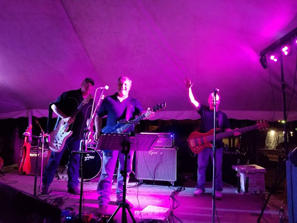 Three men playing music on a stage