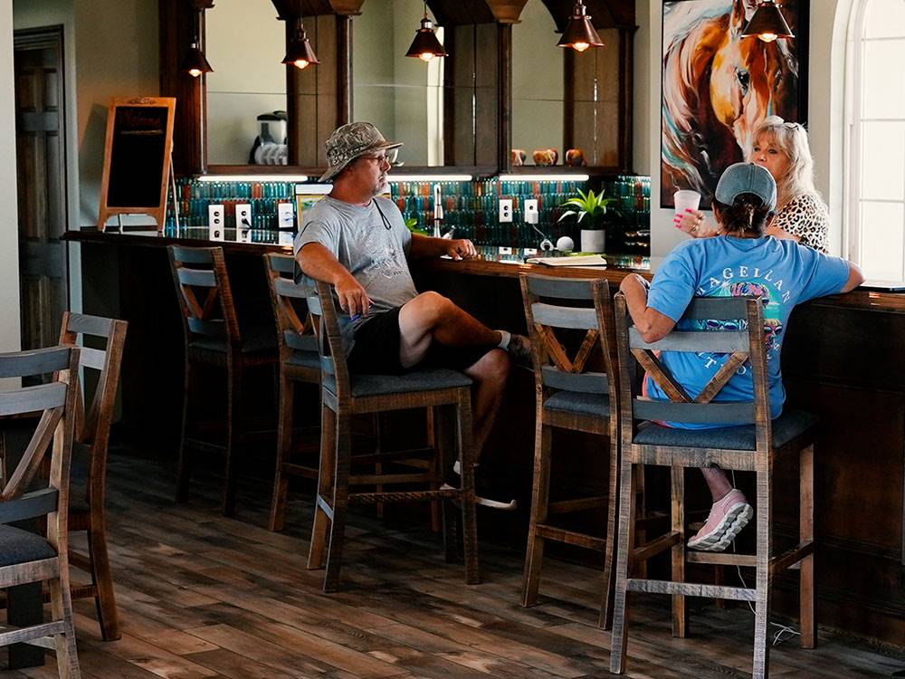 A couple sitting at the bar at Crossroads Luxury RV Park