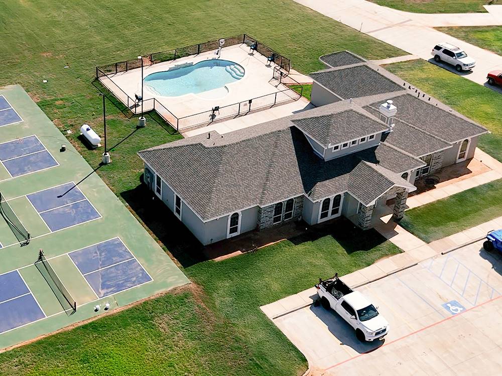 Aerial view of the office, pool and pickle ball courts at Crossroads Luxury RV Park