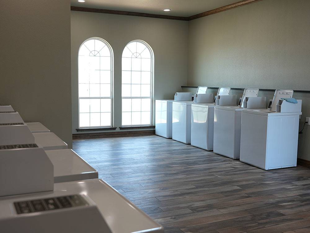 Washers and dryers in the laundry room at Crossroads Luxury RV Park