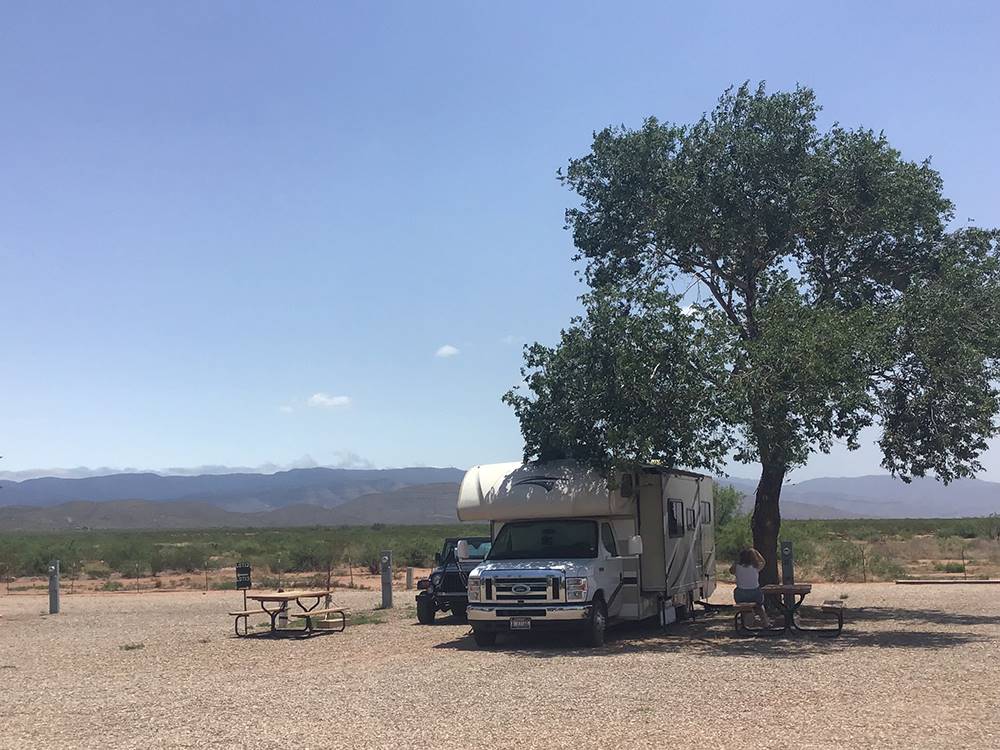 RV parked at a shaded site at Mountain Meadows RV Park