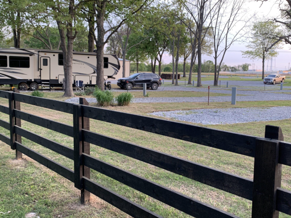 Fence in front of gravel sites at The Park on Whiskey Road