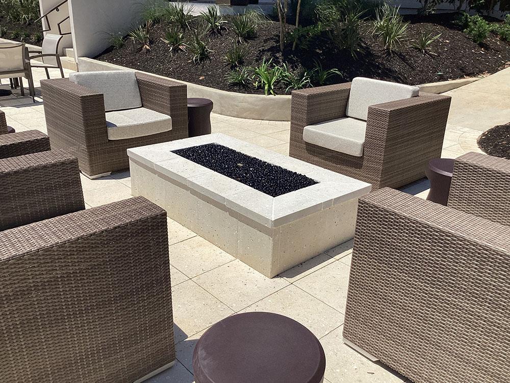 Sitting area with glowing fire table at GULFPORT LUXURY RV RESORT