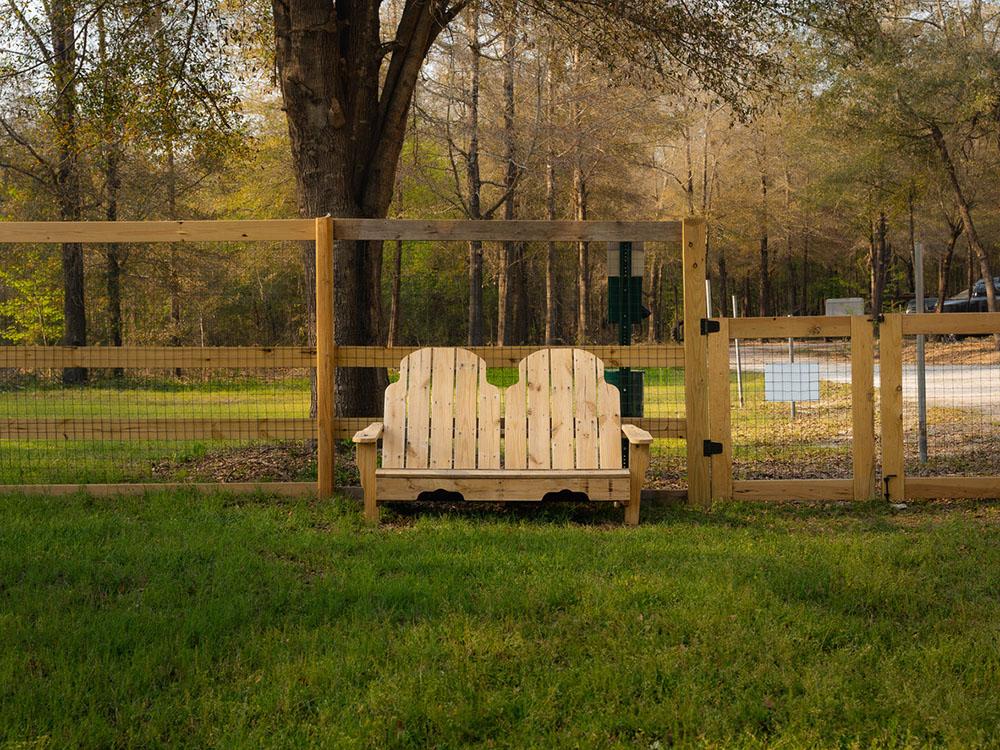 A wooden bench inside the pet area at DOGWOOD RV PARK