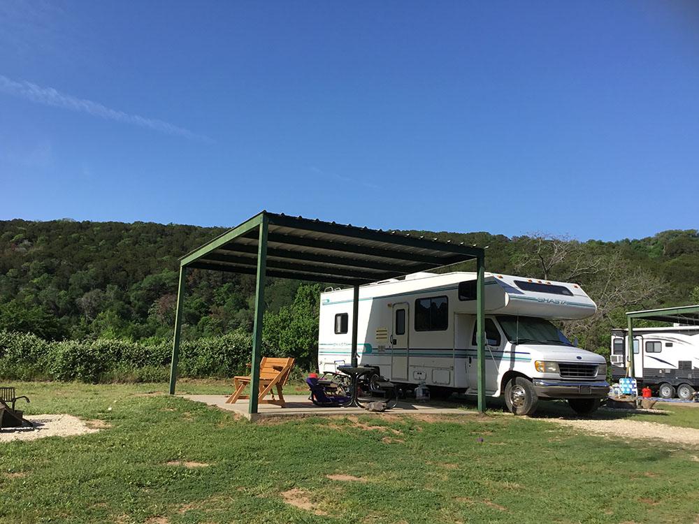 A RV parked in a site with a pagoda at BRAZOS RIVER HIDEOUT