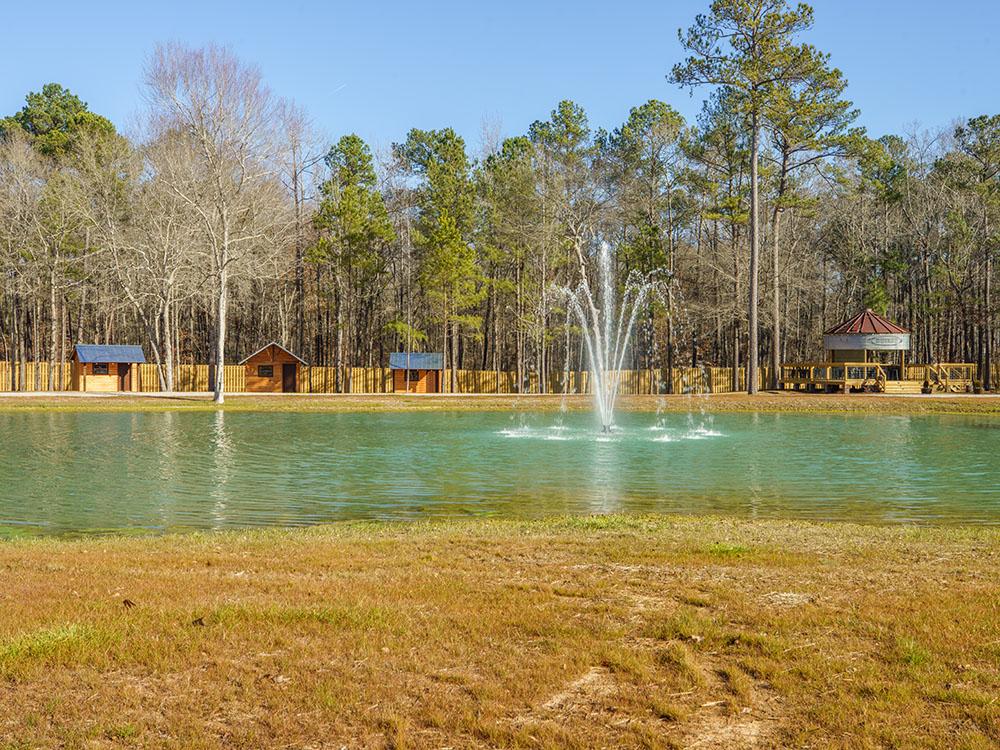 A water fountain in the pond at SANWAR RV PARK & RESORT