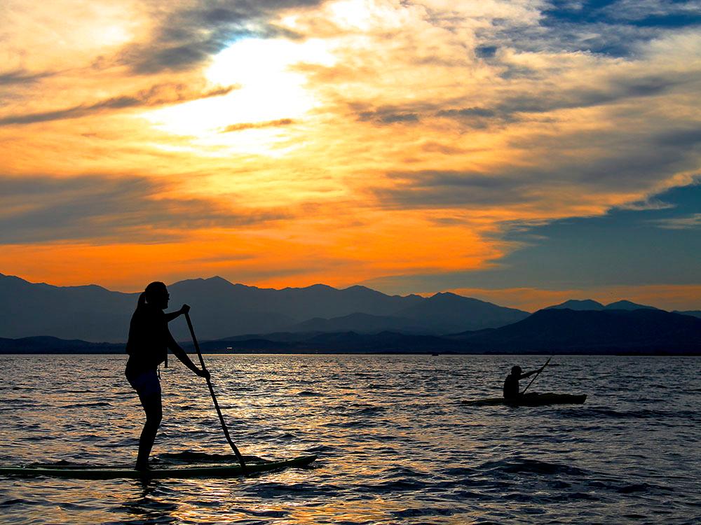 Paddle boarder at sunset at LAKE SHORE RV PARK