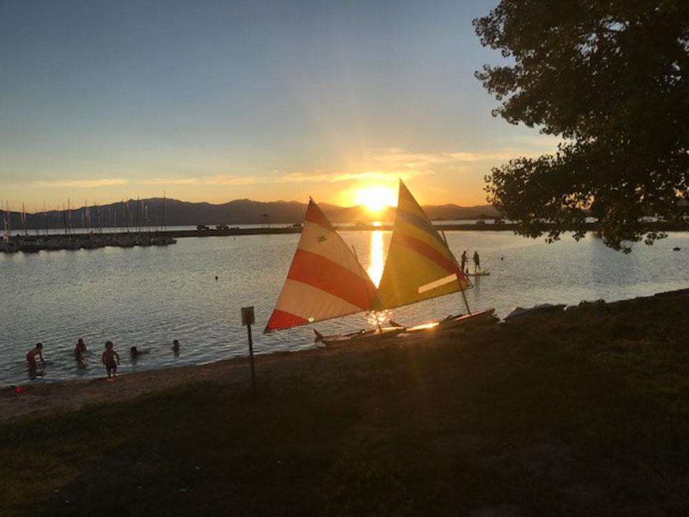 Two sailboats on the shore at LAKE SHORE RV PARK