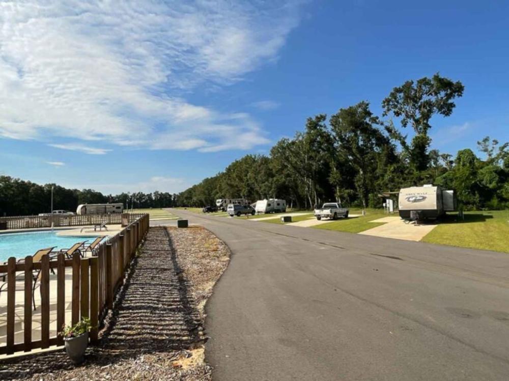 Paved road and pool area at Blue Heron Escape RV Resort