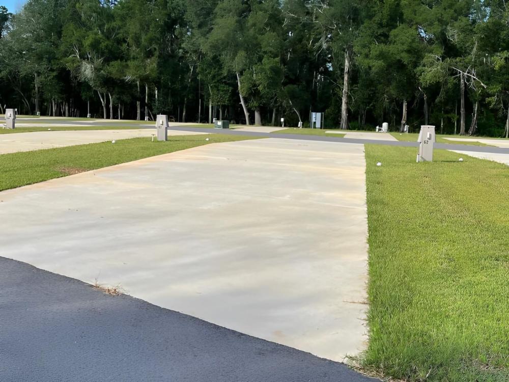 Paved open RV space at site Blue Heron Escape RV Resort