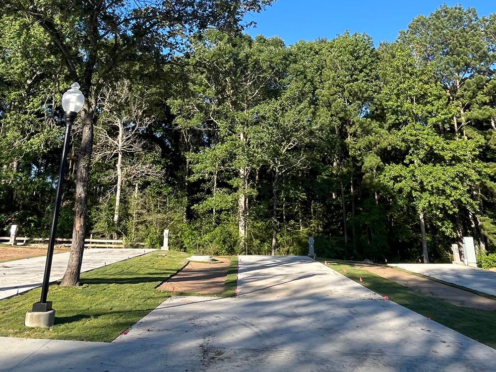 Paved RV site near trees at WILLIS HILLSIDE RV RESORT