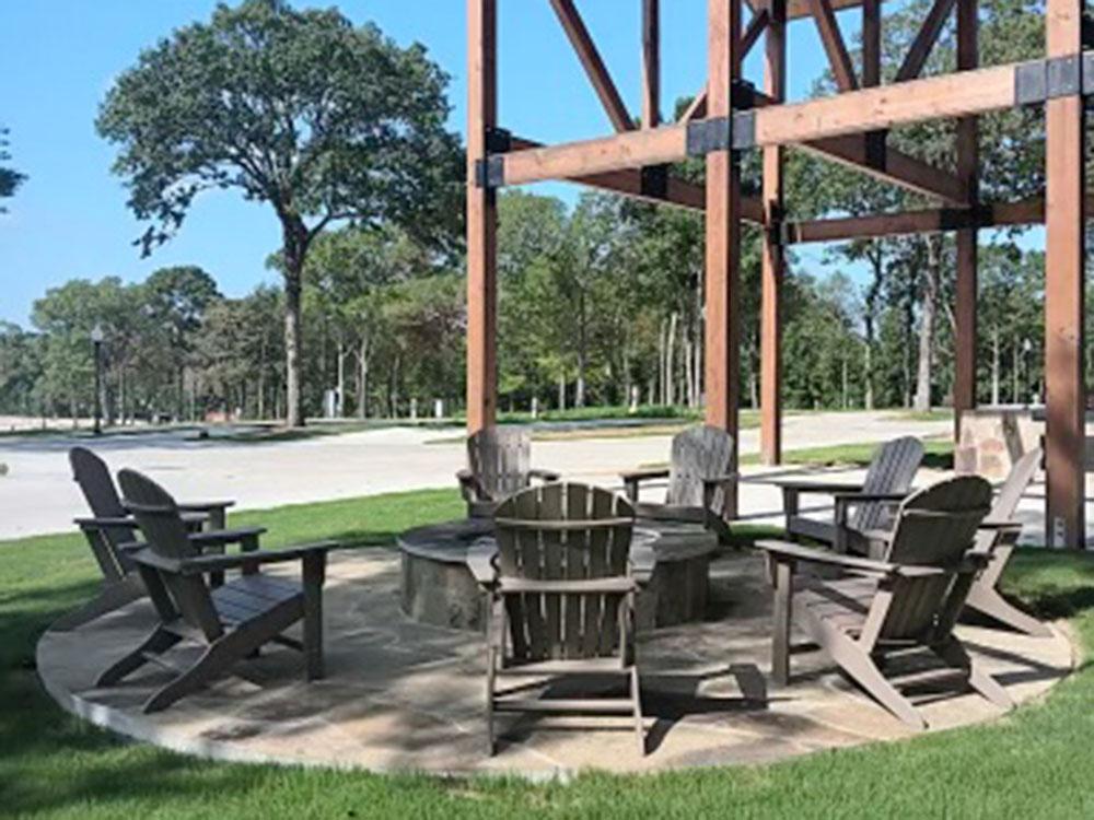 Adirondack chairs around a fire pit at WILLIS HILLSIDE RV RESORT