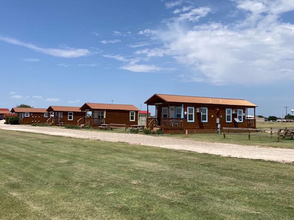 A row of cabin rentals at SILVER WIND RV PARK AND CABINS