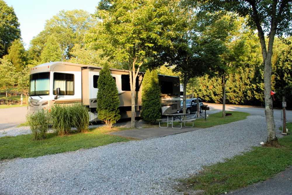 Large RV parked at a gravel site at Rocky Top Campground