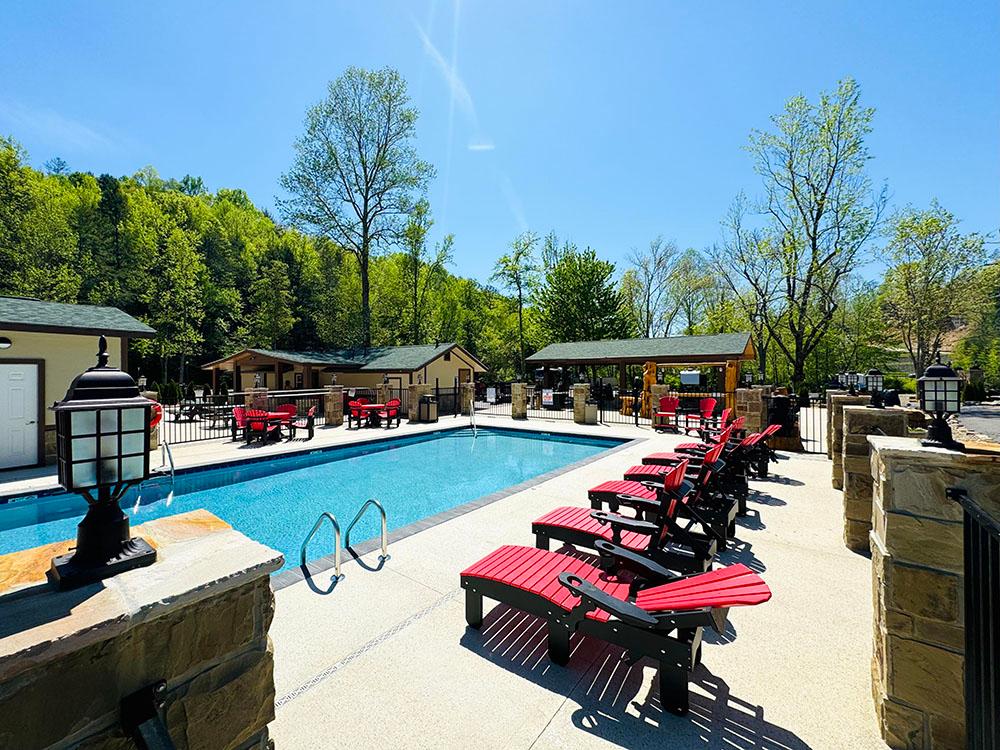 Swimming pool with lounge chairs at DUDLEY CREEK RV RESORT