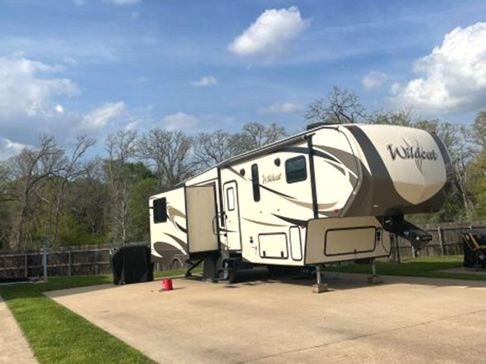 A fifth wheel parked in a RV site at TIMBER RIDGE RV PARK