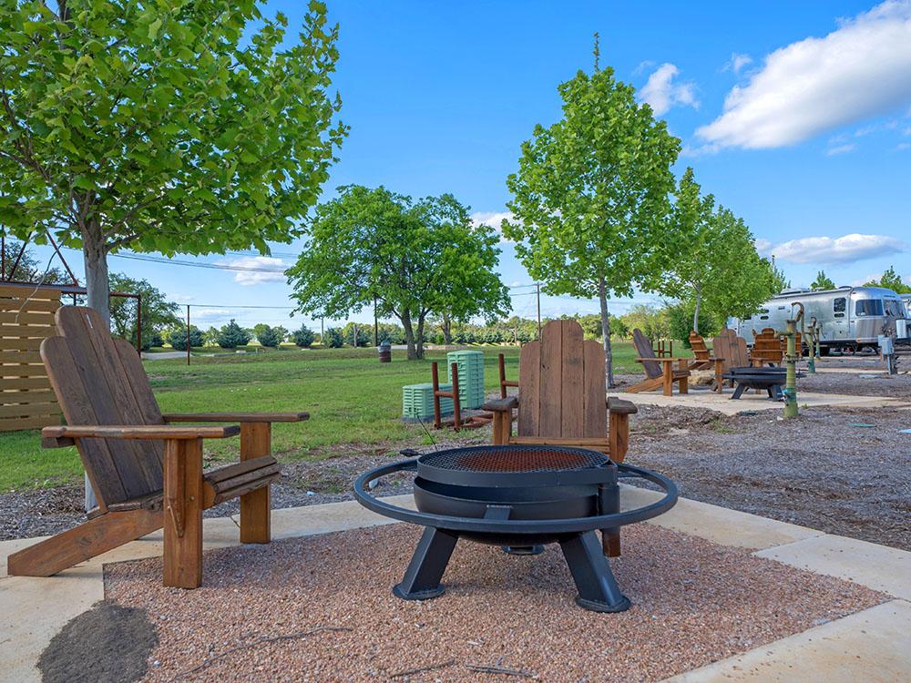 Adirondack chairs around a fire pit at STARDUST AIRSTREAM RV RESORT AT CEDAR BREAK LODGING