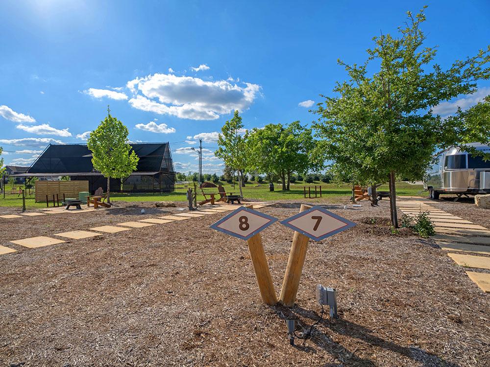 Airstream at site and a building in the distance at STARDUST AIRSTREAM RV RESORT AT CEDAR BREAK LODGING