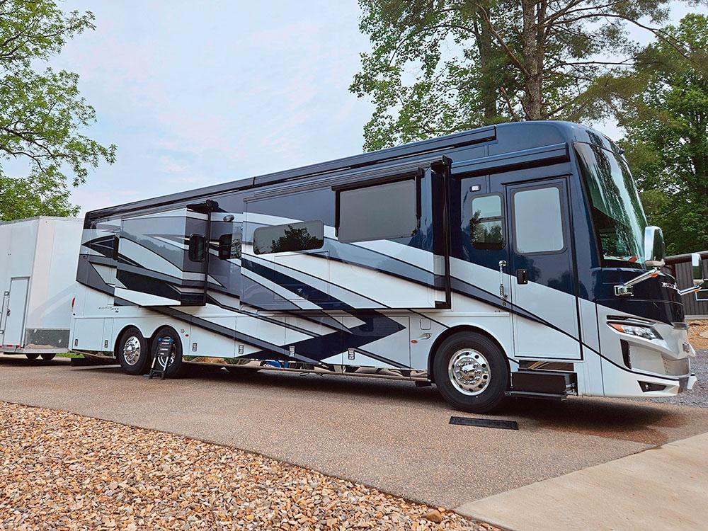 A motorhome parked in a extra, long hook up site at SMOKY MOUNTAIN PREMIUM CAMPING